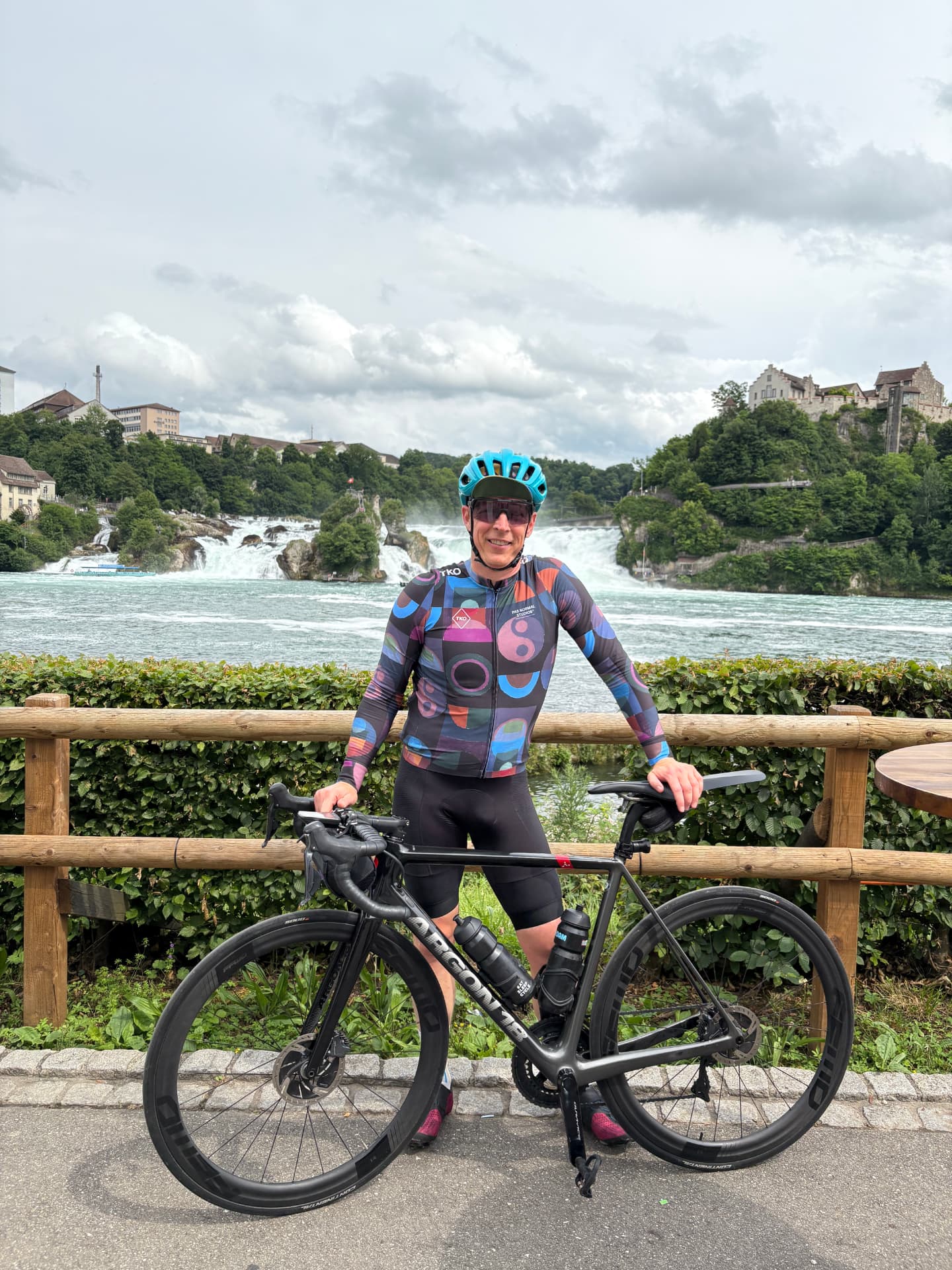Cyclist with a road bike in front of the Rheinfall waterfall near Zurich, Switzerland